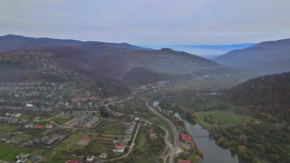 Aerial view in the mountain valley autumn landscape with small village