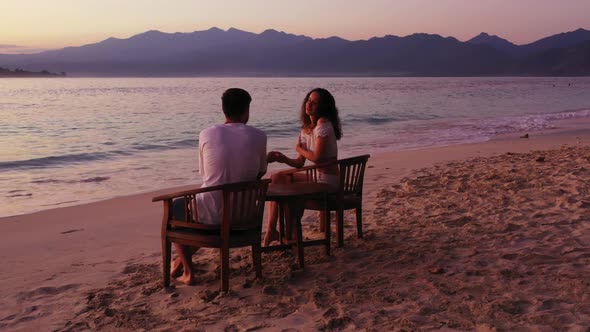 Boy and girl suntan on marine lagoon beach trip by turquoise ocean and white sandy background of Gil