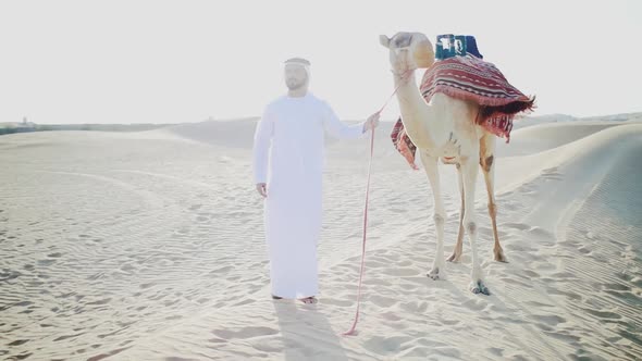 Man and his camel in the Dubai desert