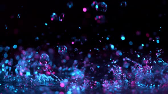 Super Slow Motion Abstract Shot of Splashing Neon Water at 1000Fps