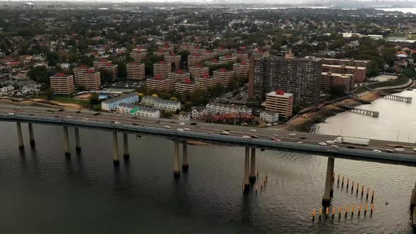 An aerial time lapse of the Queens side of the Throgs Neck Bridge from over the East River. It is a