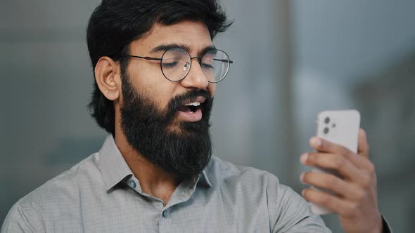 Arabian Indian Young Bearded Man Businessman Handsome Entrepreneur Hold Smartphone Talking Online