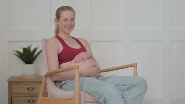 Smiling Pregnant Woman Looking at Camera
