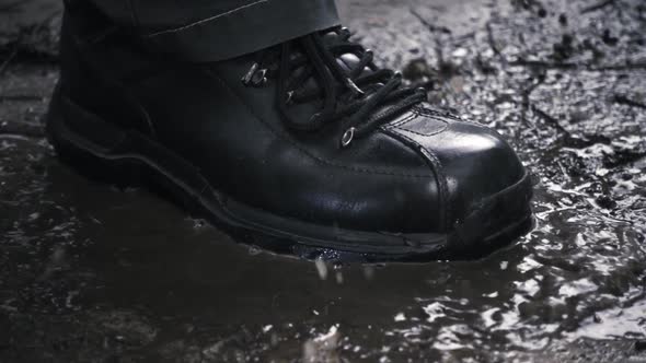 Black New And Glossy Boots Step On A Puddle 2