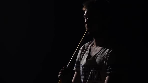 Young Bearded Man Smoking Hookah, Exhaling White Smoke on Black Isolated Background in Slow Motion.