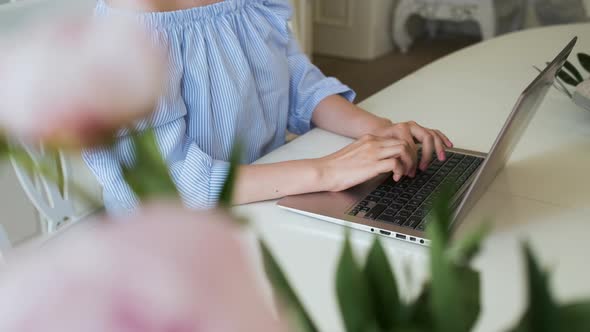 Female Freelancer Typing Text on the Laptop Keyboard
