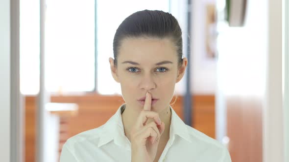 Gesture of Silence by Woman, Finger on Lips