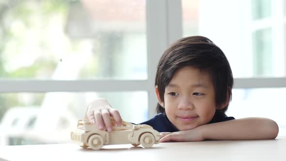 Cute Asian Child Playing Wood Model Cars Slow Motion