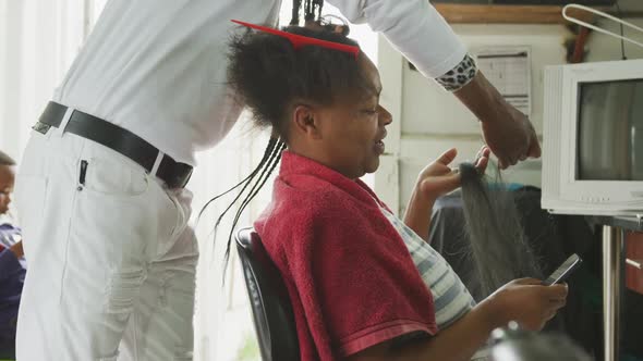 African man adding hair extensions