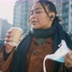 Young woman removing face mask and drinking coffee on street, Italy - VideoHive Item for Sale