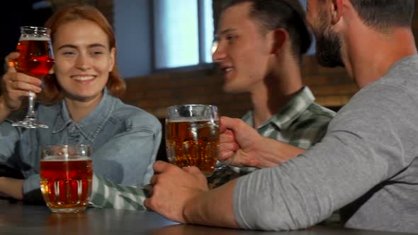 Group of Young Friends Enjoying Drinks at the Bar