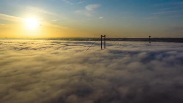 Aerial hyper-lapse drone flight towards the fog on the Humber surrounding the Humber Bridge