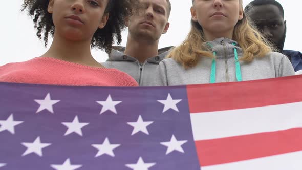 Young People Silently Holding American Flag Honoring Shooting Victims, Mourn