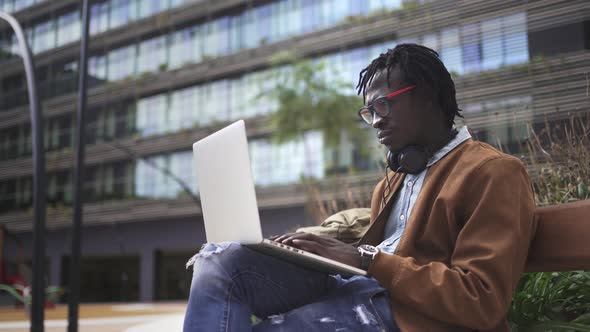 Young Black Professional working on a computer in a business district