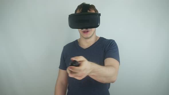 Young Man In A Modern Helmet Of Virtual Reality In A Simulation Game