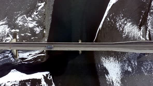 Car Crossing a Bridge on Icelandic Roads During the Winter