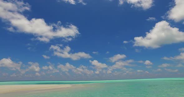 Daytime birds eye copy space shot of a white sand paradise beach and blue ocean background in colorf