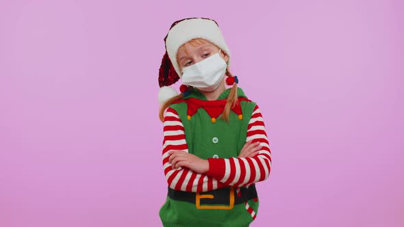 Girl Christmas Santa Claus Elf in Face Mask PPE to Safe From Coronavirus on Lockdown Quarantine