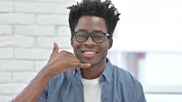 Young African Man Asking for Call with Hand Sign 