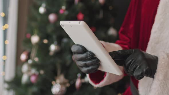 Hands of Santa Using Digital Tablet