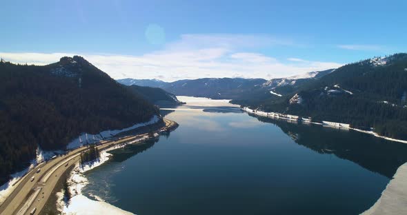 Aerial Frozen Lake Shore Above Snoqualmie Pass Wa Interstate 90 Traffic