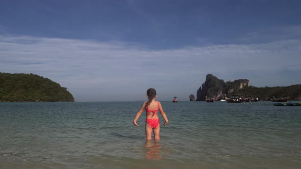 Girl Playing In Water At The Beach