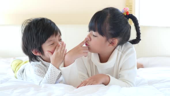 Cute Asian Children Playing On White Bed