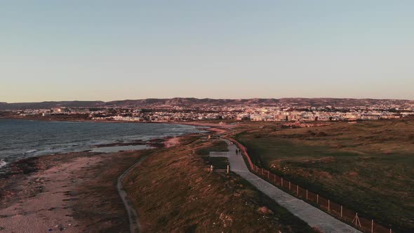 Aerial Drone View of Paphos City and Sunset Mediterranean Sea Quay with Pedestrians Walking