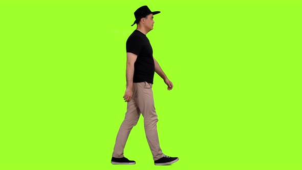 Walking Man in Black T-shirt and Cowboy Hat