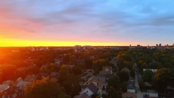 Aerial view of a beautiful sunset in Minneapolis suburbs area during golden hour, homes houses