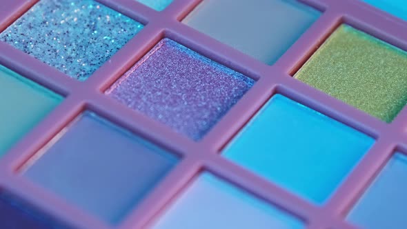 Make up pigment bright colorful eyeshadow palette in neon light.