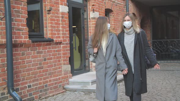 Two Beautiful Smiling Women in Medical Masks Walking at the City. Consumerism, Lifestyle Concept