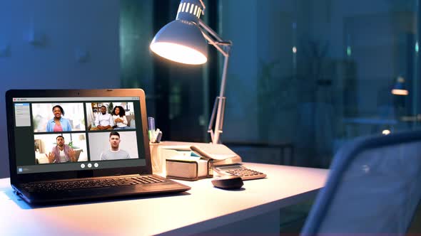 Group Video Chat Windows on Laptop at Night Office