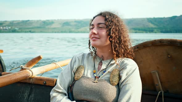 A Viking Woman Sits on Board the Drrakar
