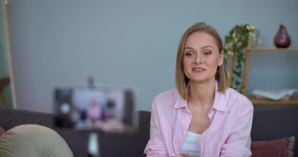 Cheerful Young Woman Looking To Smartphone Camera While Recording Video at Home. Female Good Looking