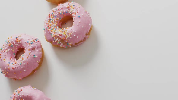 Video of donuts with icing on white background