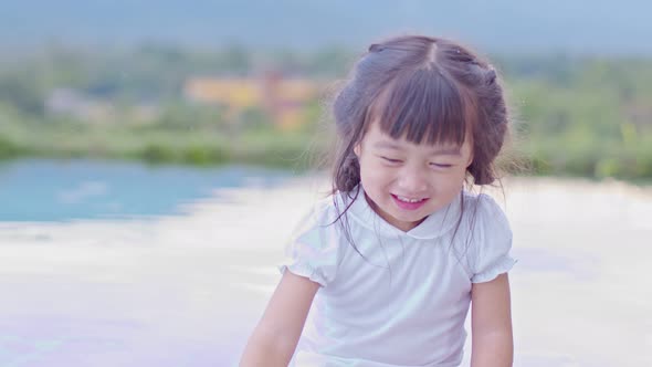 Adorable little girl laughing and happiness playing on swimming pool