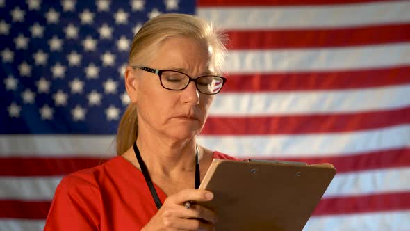 Medium tight portrait of concerned healthcare nurse looking at clipboard and then at camera with con