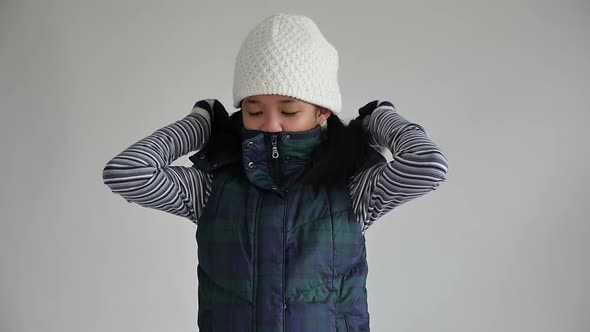 Cute Asian Girl In Winter Clothes On Gray Background Isolated Slow Motion