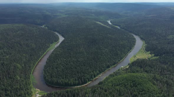 top view of bend of river, located in the forest