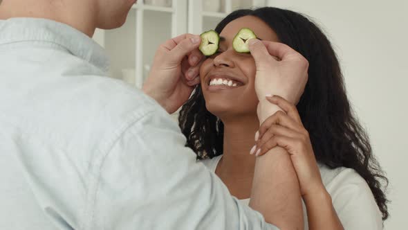 Husband Making Surprise For Wife Preparing Romantic Dinner In Kitchen