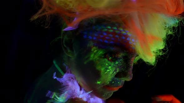 Sexually and Creative Image with Fluorescent Paints on Female Skin Woman in Uv Light