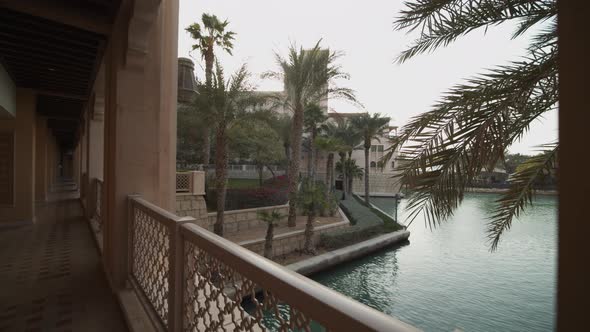 Reveal of Water Canal Surrounded By Bars and Palm Trees in Dubai Luxury Hotel Resort