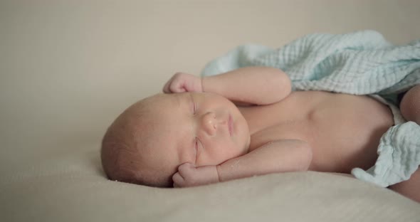 Sleeping Newborn Baby in Plaid