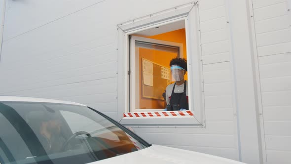 Man Driver Getting Takeaway Coffee at Drive Thru Restaurant