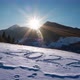 The sun sets behind the mountain, clear blue sky. Year 2022 written in the snow. - VideoHive Item for Sale