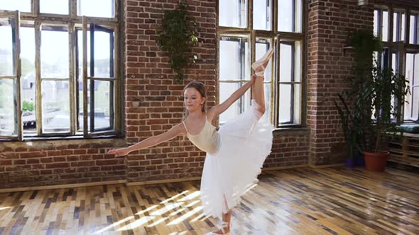 Graceful Teen Girl Practicing Exercise Classical Ballet in Sport School