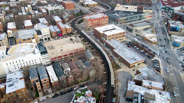 Train on Railroad Tracks in Inner City Urban Streets of Chicago, Aerial