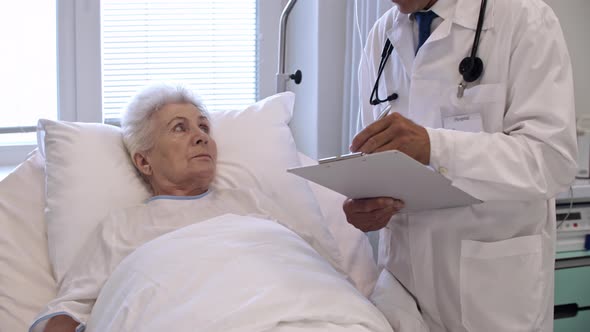 Senior Woman on Hospital Bed Listening to Doctor