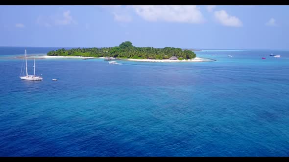 Aerial drone shot landscape of tropical seashore beach trip by turquoise lagoon with white sandy bac